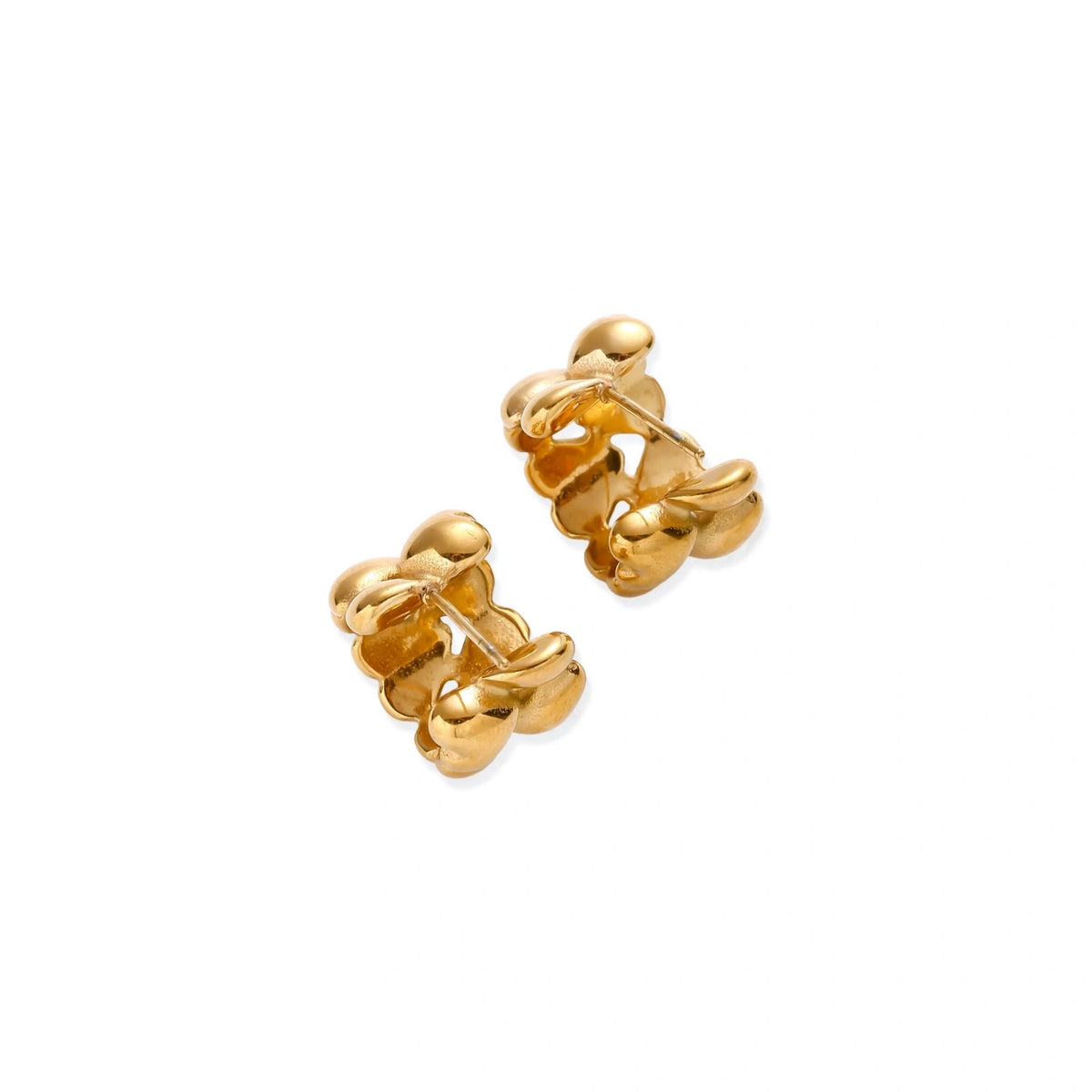Close-up of gold-plated twisted rope huggie hoop earrings with brushed finish on white background.