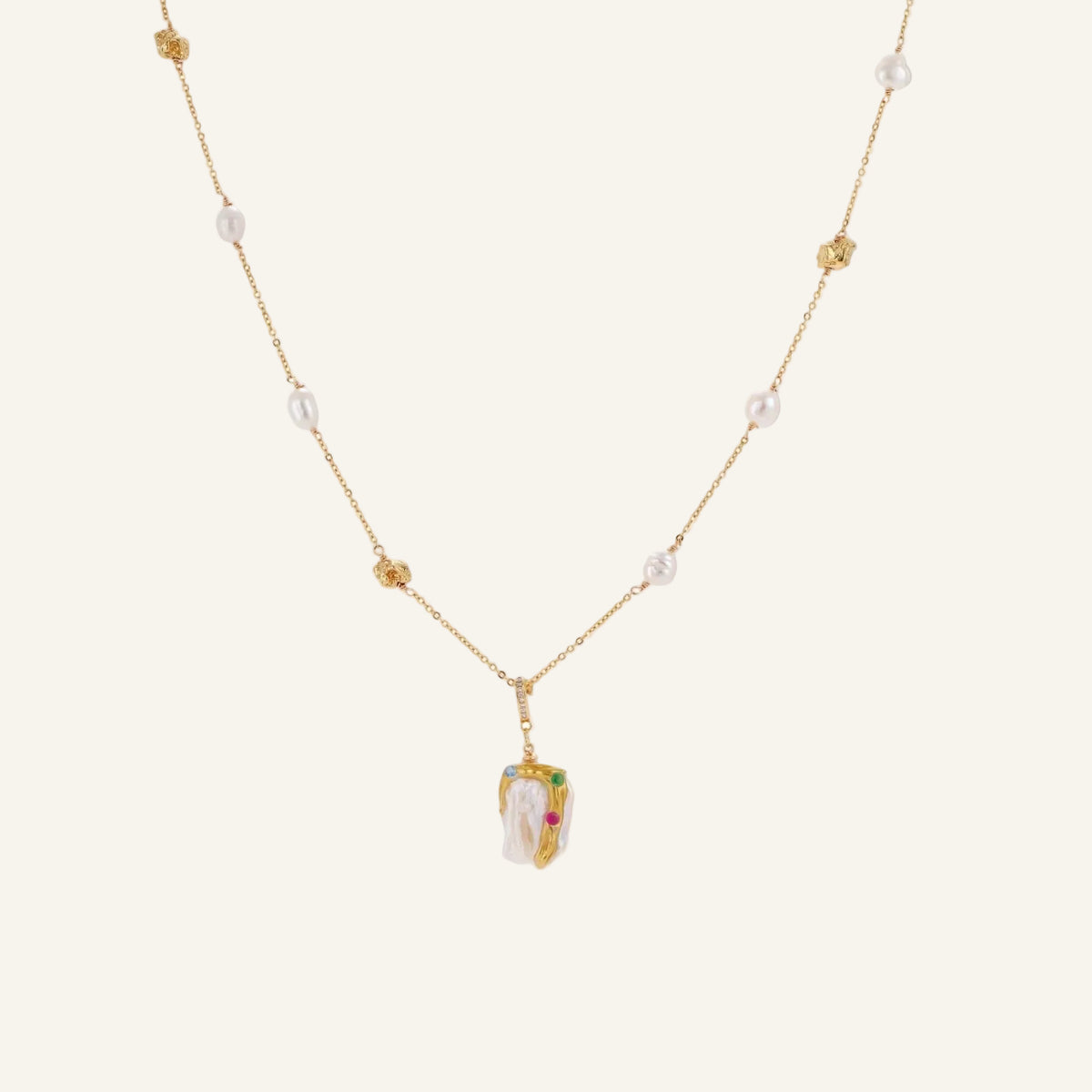 Delicate 18k gold-plated chain with baroque pearls and colorful enamel pendant featuring blue, pink accents on cream background.