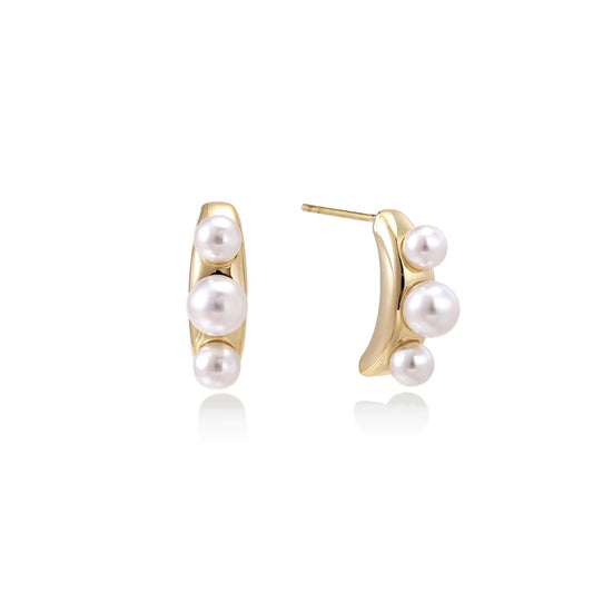 14K gold-plated curved stud earrings with three white freshwater pearls aligned vertically on cream background