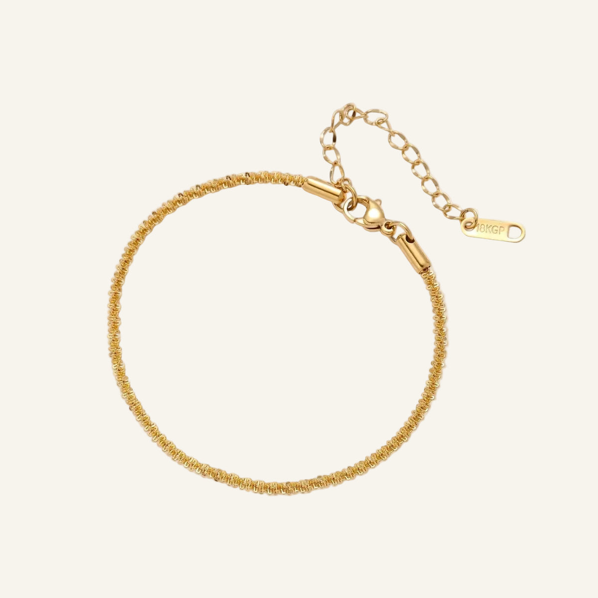 Delicate 18K gold-plated stainless steel bracelet with textured beaded chain on cream background