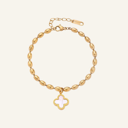 18K gold-plated oval bead bracelet with a four-leaf clover charm in mother-of-pearl or black enamel, adjustable lobster clasp, on white background.
