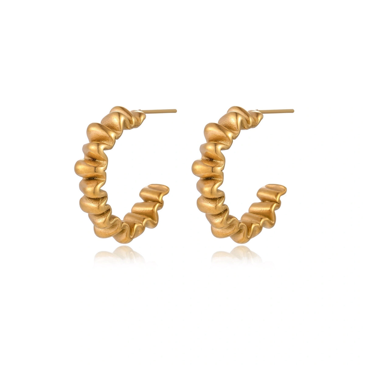 Sculptural gold-plated hoop earrings with continuous twisted spiral design on cream background