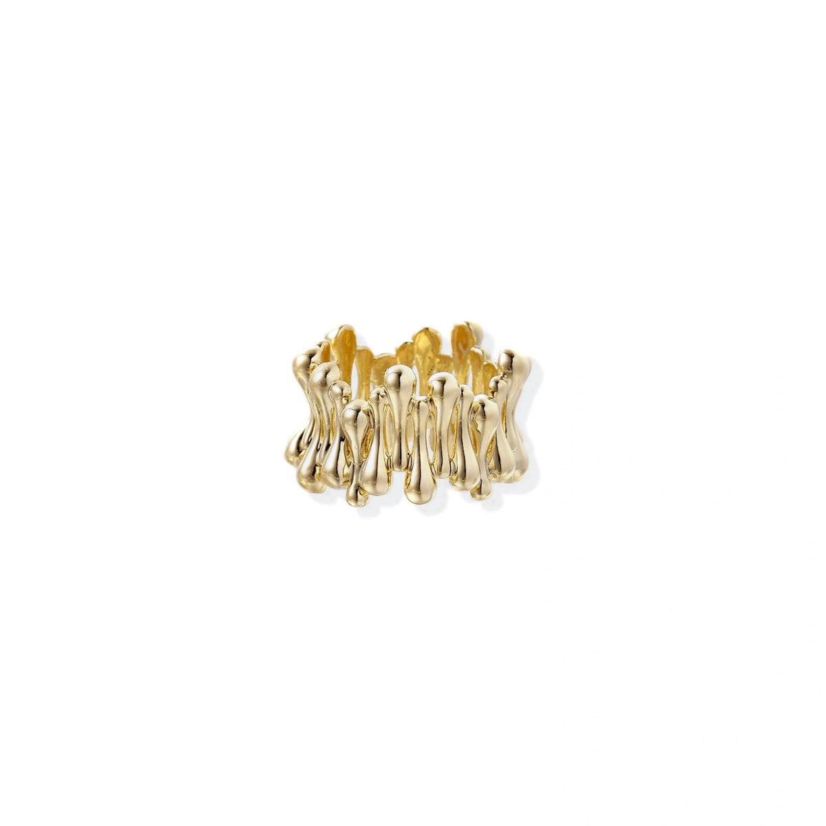 Gold-plated brass ring with sculptural petal-like elements in a wide band design on beige background