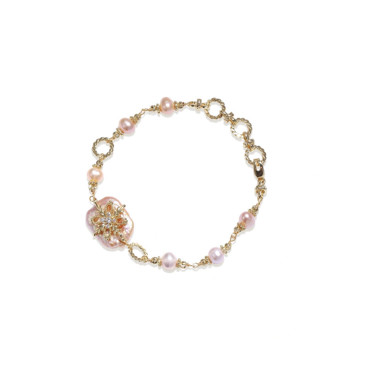 Gold-plated bracelet with pink baroque pearl centerpiece, floral connector, and freshwater pearls