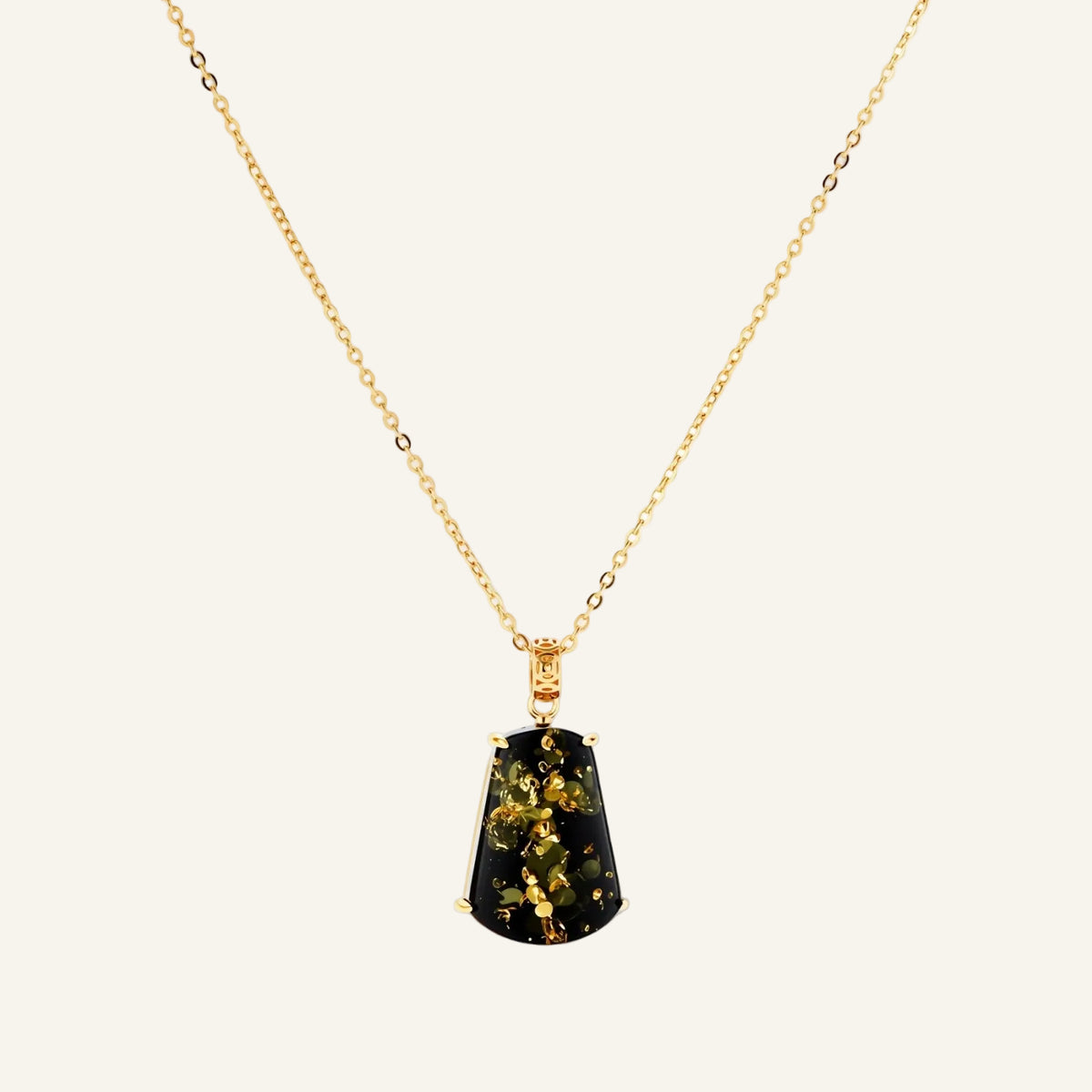 18k gold-plated necklace and earrings with green amber pendants featuring golden inclusions on cream background