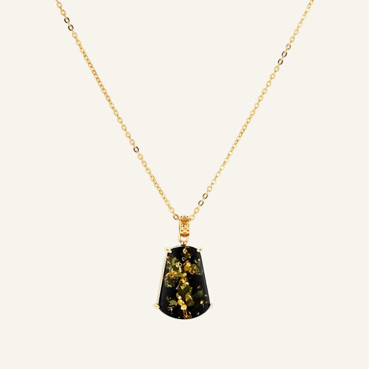 18k gold-plated necklace and earrings with green amber pendants featuring golden inclusions on cream background