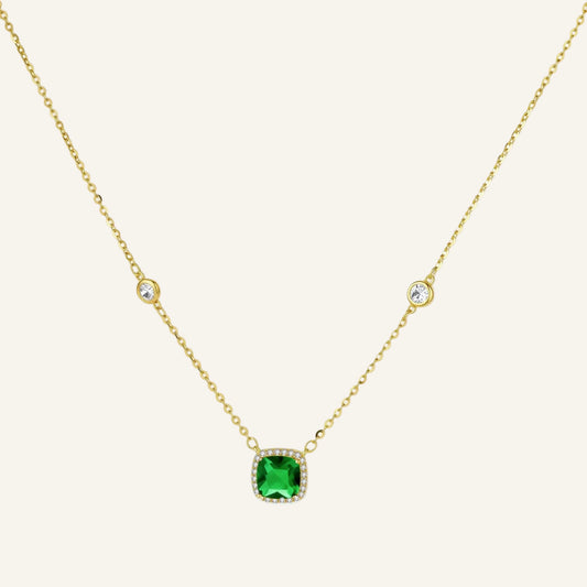 Delicate gold chain necklace featuring square emerald pendant with crystal halo and station accents