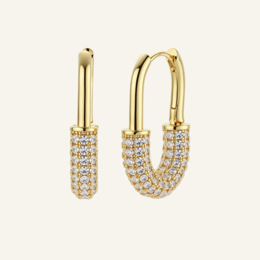 Gold-plated huggie hoop earrings with pavé zirconia stones covering the bottom curve, shown in open and closed positions.